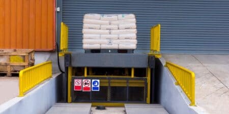 Loading dock leveler ramp outside warehouse building for loading and unloading cargo,Part of industrial or commercial building