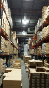 A spacious warehouse filled with neatly stacked boxes and shelves, ready for efficient storage and organization.