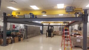 Warehouse with crane and industrial machinery.