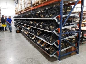 A warehouse filled with neatly organized bins on racking.