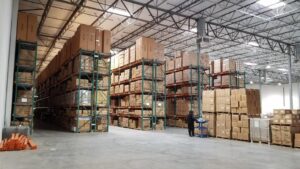 A warehouse filled with boxes and pallets, ready for shipping and distribution.