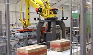 A pallet robot assembling products on a conveyor belt in a factory.