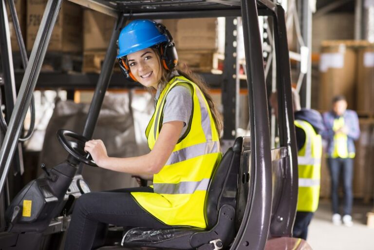 lady in forklift wearing safety helmet with ear coverings