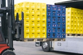 Extending forks that are carrying 2 loads of pallets in a line onto a truck.