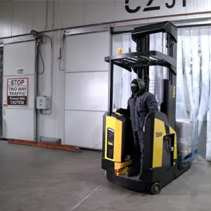 Yale Reach Truck Operated by man in cold weather gear coming out of freezer