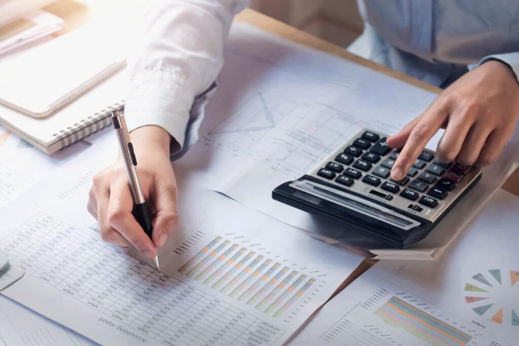 Professional engaged in a detailed business analysis with charts and graphs.