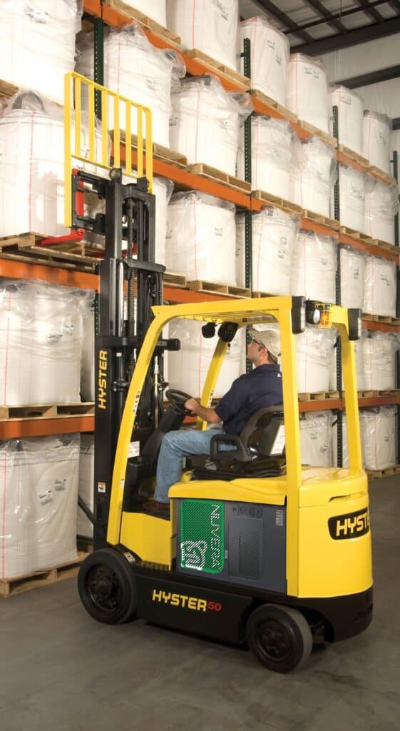 Hyster Electric Sit Down Forklift Lifting Product Into Storage Rack