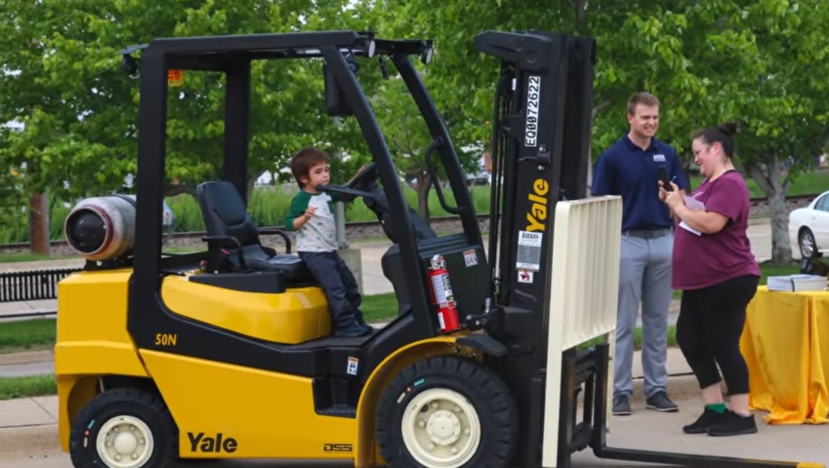 A young boy pretends to drive a forklift at Sioux City's Big Truck Night.