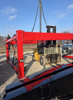 top of the frame of the combilift SC3 straddle carrier around a yellow yale forklift to show dimensions.