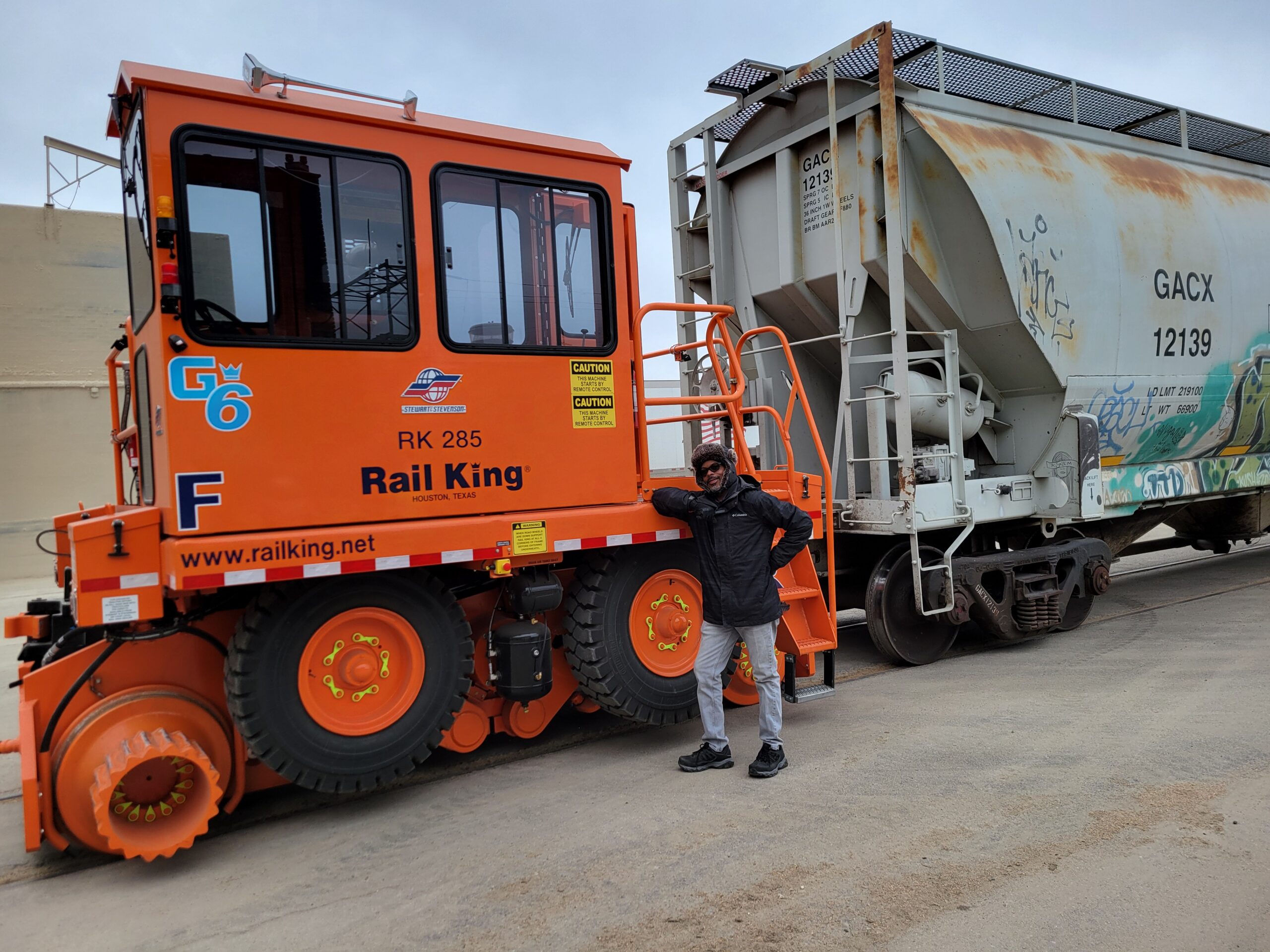 Technician standing by a Railking rail car mover
